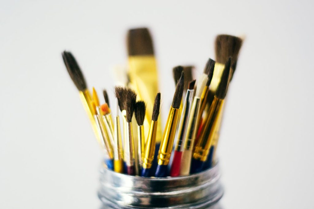 A diverse set of paintbrushes displayed in a jar, perfect for arts and crafts enthusiasts.